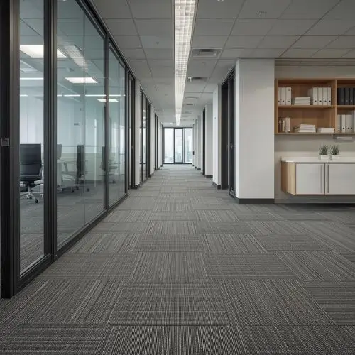 Dark charcoal and navy blue Nylon Interlocking Carpet Tiles installed in a modern corporate office lounge with natural lighting.