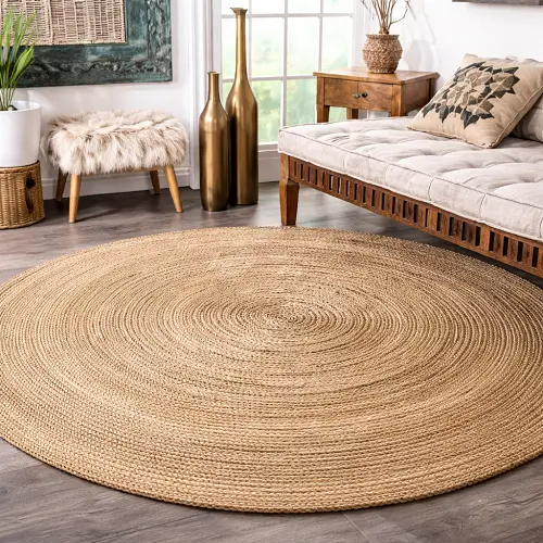 Cozy living room featuring a round handwoven jute rug with natural spiral texture, placed on a wooden floor and complemented by a cushioned daybed, decorative pillows, indoor plants, and rustic décor for a warm, earthy ambiance.