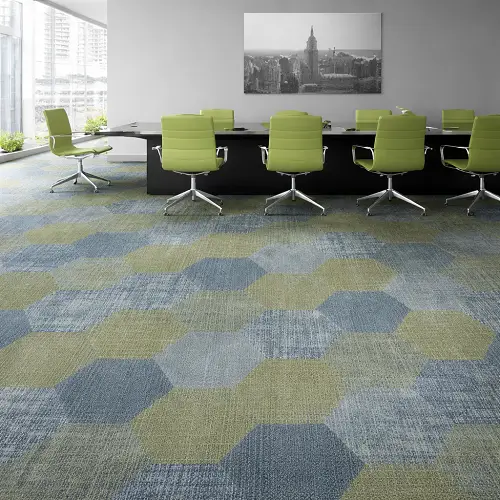Modern conference room with green and blue cut pile office carpet tiles flooring, featuring hexagonal pattern design and ergonomic office chairs in a corporate workspace
