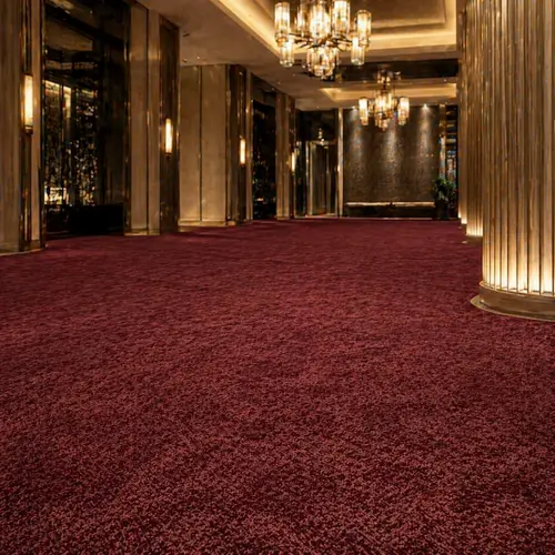 Seamless premium burgundy broadloom carpet in upscale UAE hotel lobby